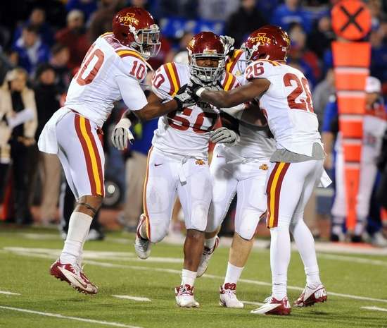 Cyclone defenders celebrate an interception by Willie Scott - John Rieger-US PRESSWIRE